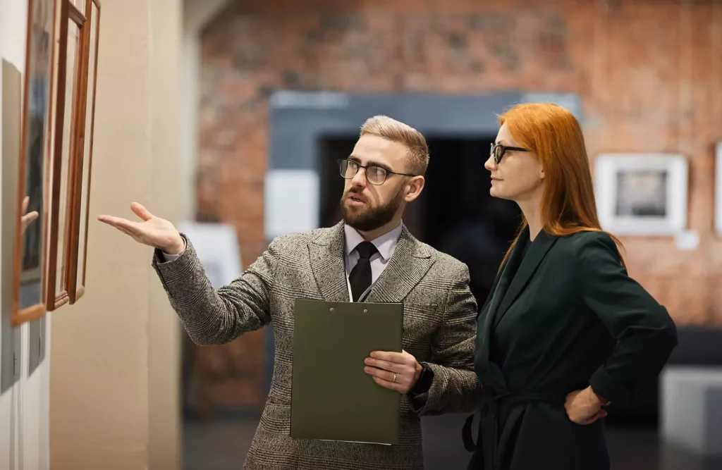 Man and woman at Art Gallery looking at painting